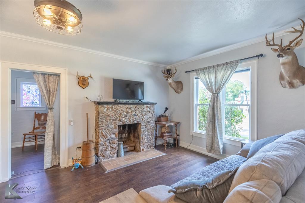 202 East Ross Street Rising Star, TX 76471 - Photo 10 of 40 a living room with furniture and a fireplace