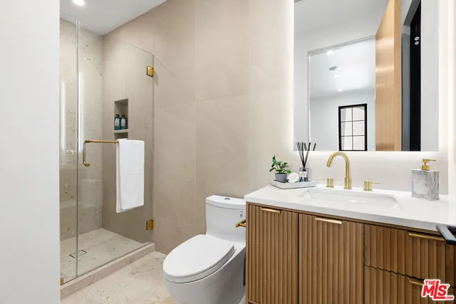 a bathroom with a sink a mirror and a lamp