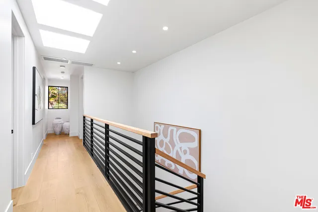 a bed room with two beds and a potted plant