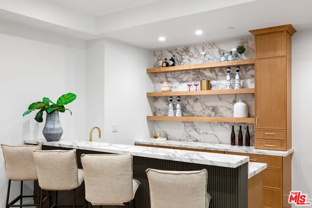 a bathroom with a granite countertop sink a toilet and shower