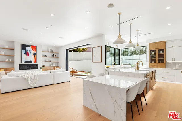 a kitchen with a table chairs and white cabinets