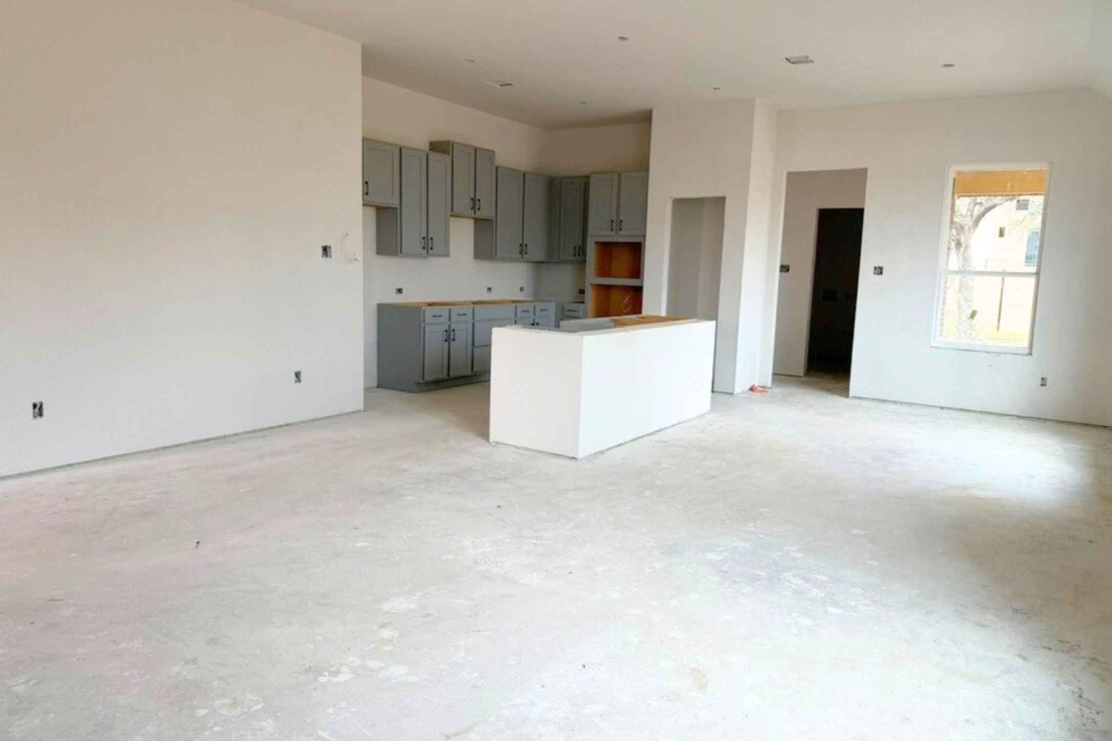 410 Raleigh Drive Georgetown, TX 78633 - Photo 39 of 40 Kitchen with gray cabinets, open floor plan, concrete floors, and a center island