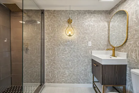 a bathroom with a sink toilet and shower