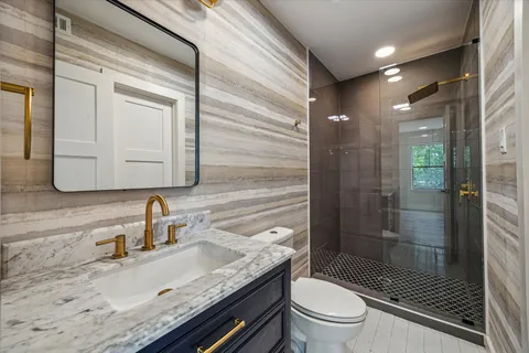 a bathroom with a sink toilet and shower