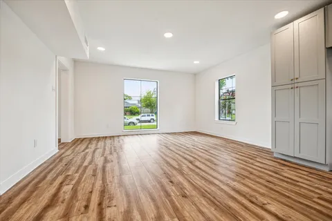 an empty room with windows and entrance