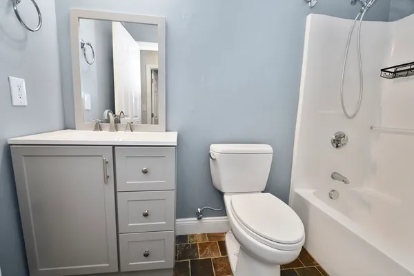 a bathroom with a toilet a sink and a bathtub