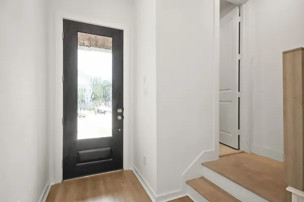 a view of hallway with bathroom and front door