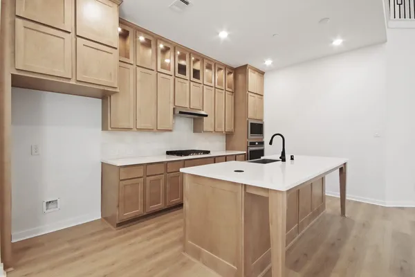 a kitchen with a sink stove and cabinets