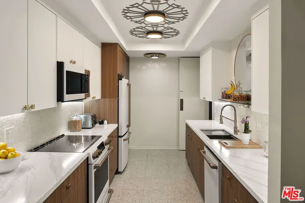 a kitchen that has a lot of cabinets in it