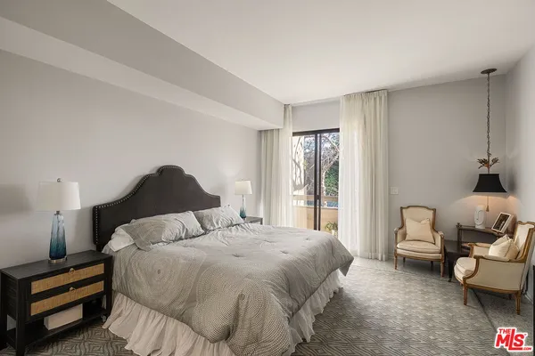 a bedroom with a bed and a couch