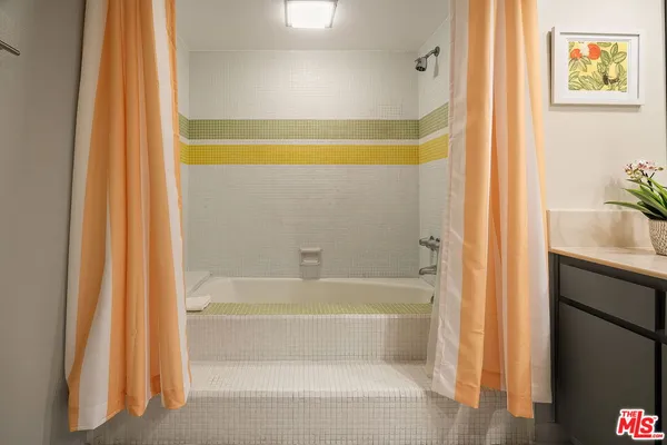 a bathroom with a bathtub and shower