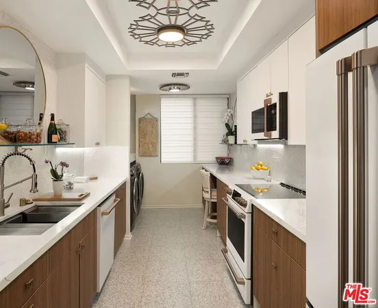 a kitchen with stainless steel appliances a sink stove and cabinets