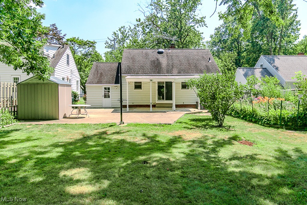 5223 Edenhurst Road Cleveland, OH 44124 - Photo 50 of 50 Back of house featuring roof with shingles, a shed, and a patio