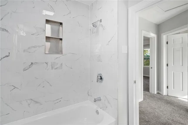 a bathroom with a bathtub and shower