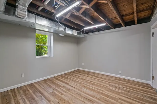 a view of room with window and wooden floor