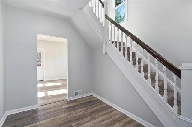 a view of an entryway with wooden floor