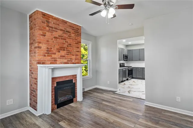 a view of kitchen with livingroom and fireplace