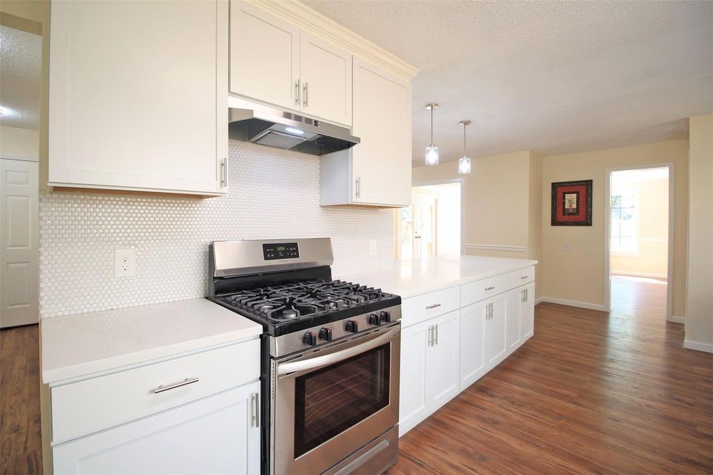 8011 Goldengrove Drive Spring, TX 77379 - Photo 14 of 48 a kitchen with granite countertop a stove and a sink