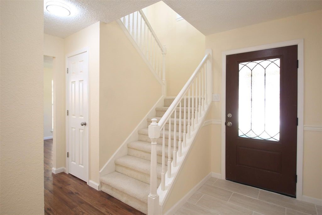 8011 Goldengrove Drive Spring, TX 77379 - Photo 22 of 48 a view of entryway with wooden floor and stairs