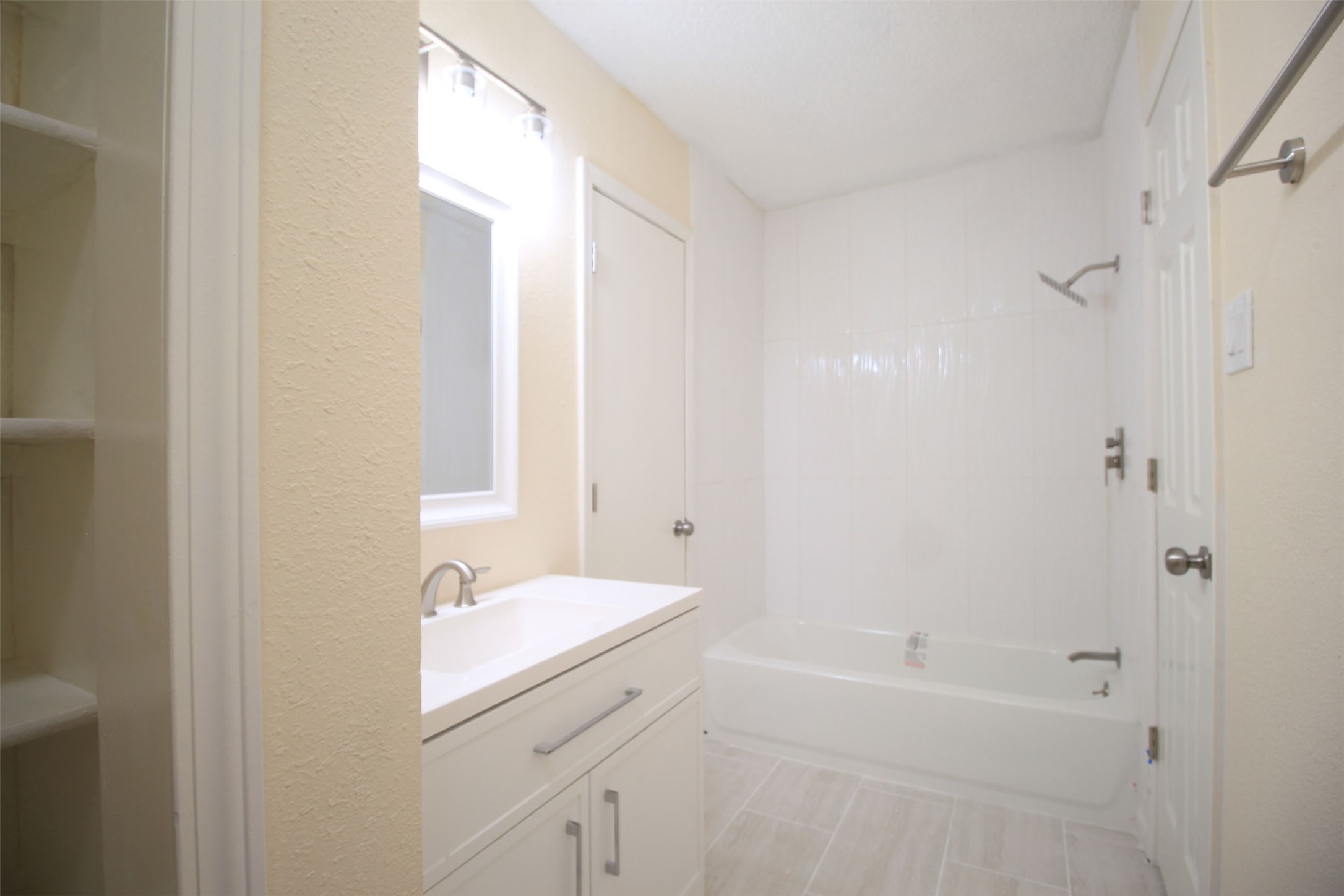 8011 Goldengrove Drive Spring, TX 77379 - Photo 43 of 48 a bathroom with a bathtub sink vanity and a mirror