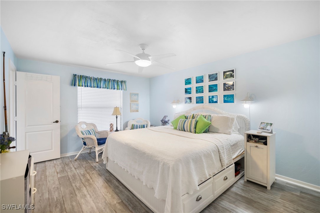 13241 Whitehaven Lane, Unit 803 Fort Myers, FL 33966 - Photo 13 of 22 a bedroom with a bed and a large window