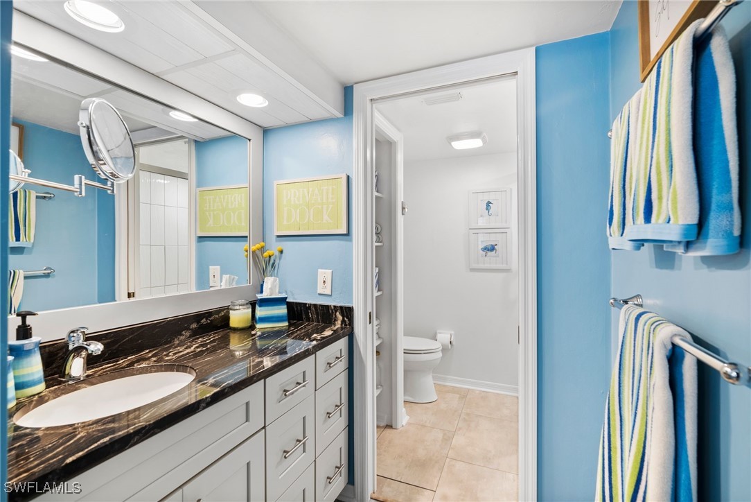 13241 Whitehaven Lane, Unit 803 Fort Myers, FL 33966 - Photo 14 of 22 a spacious bathroom with a granite countertop sink and a mirror