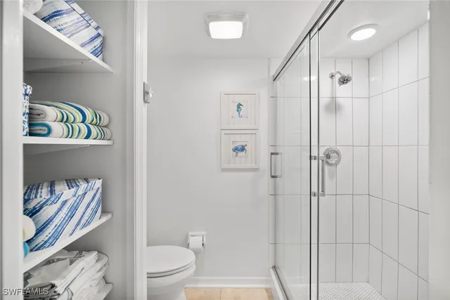 a bathroom with a shower curtain and a toilet