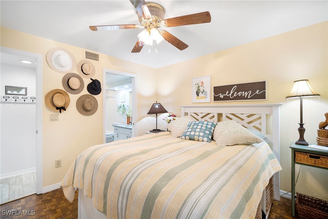 13241 Whitehaven Lane, Unit 803 Fort Myers, FL 33966 - Photo 18 of 22 a bedroom with a bed and a lamp on the dresser