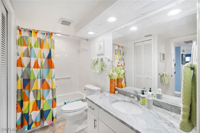 a bathroom with a sink a toilet and shower curtain