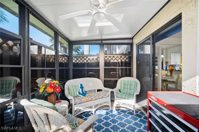 a living room filled with furniture and a large window