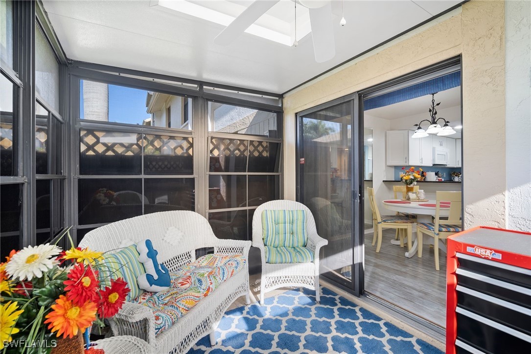 13241 Whitehaven Lane, Unit 803 Fort Myers, FL 33966 - Photo 21 of 22 a living room with furniture and a floor to ceiling window