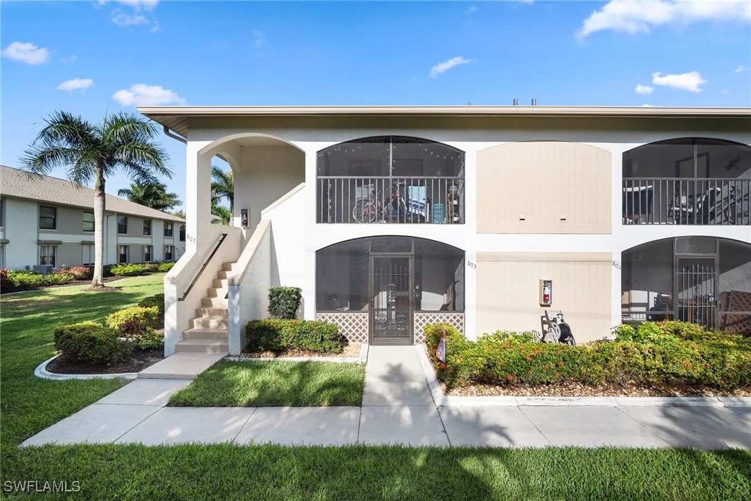 13241 Whitehaven Lane, Unit 803 Fort Myers, FL 33966 - Photo 5 of 22 a front view of a house with a yard