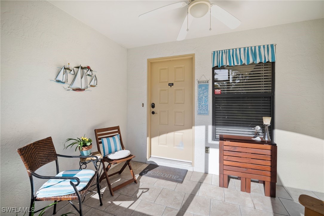 13241 Whitehaven Lane, Unit 803 Fort Myers, FL 33966 - Photo 6 of 22 a bedroom with a bed and a chandelier