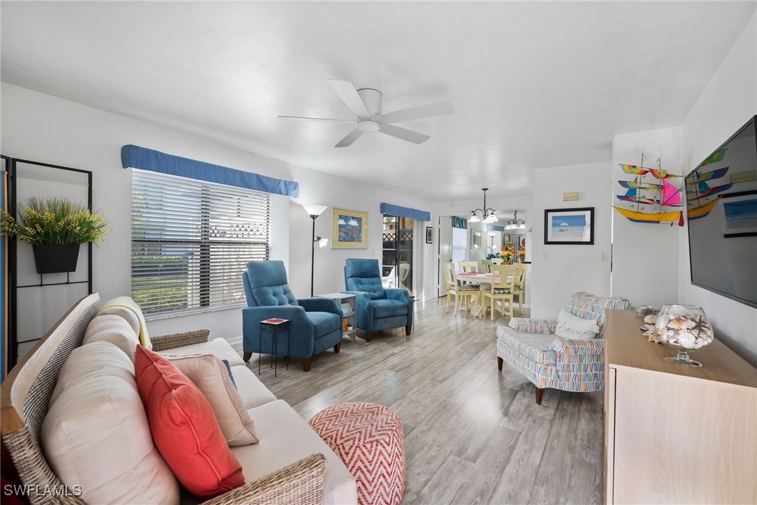 13241 Whitehaven Lane, Unit 803 Fort Myers, FL 33966 - Photo 7 of 22 a living room with furniture and a large window