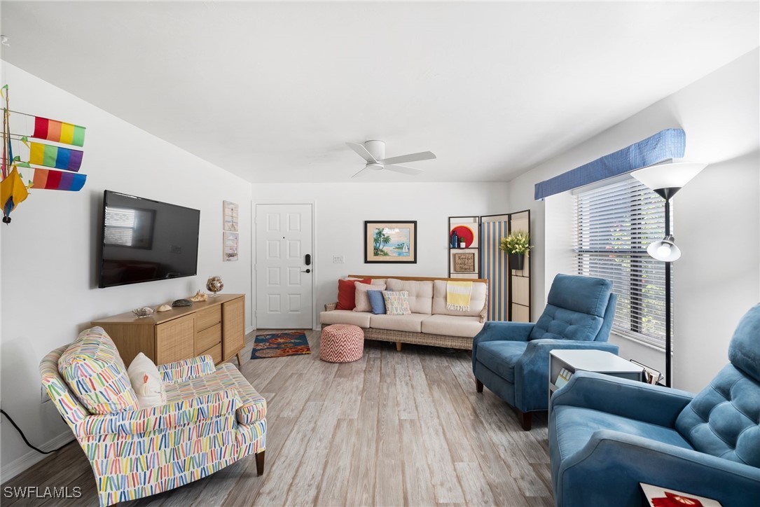 13241 Whitehaven Lane, Unit 803 Fort Myers, FL 33966 - Photo 8 of 22 a living room with furniture and a flat screen tv