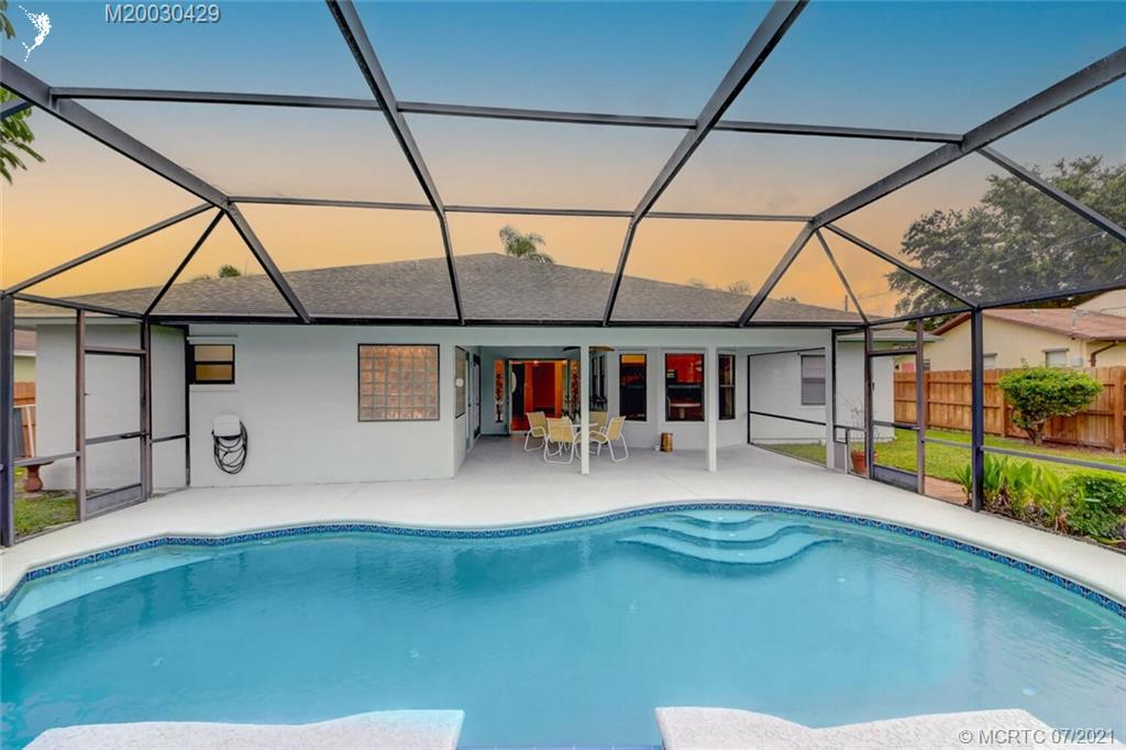 2126 Southeast Dolphin Road Port St. Lucie, FL 34952 - Photo 2 of 30 a swimming pool with barbeque in front of it