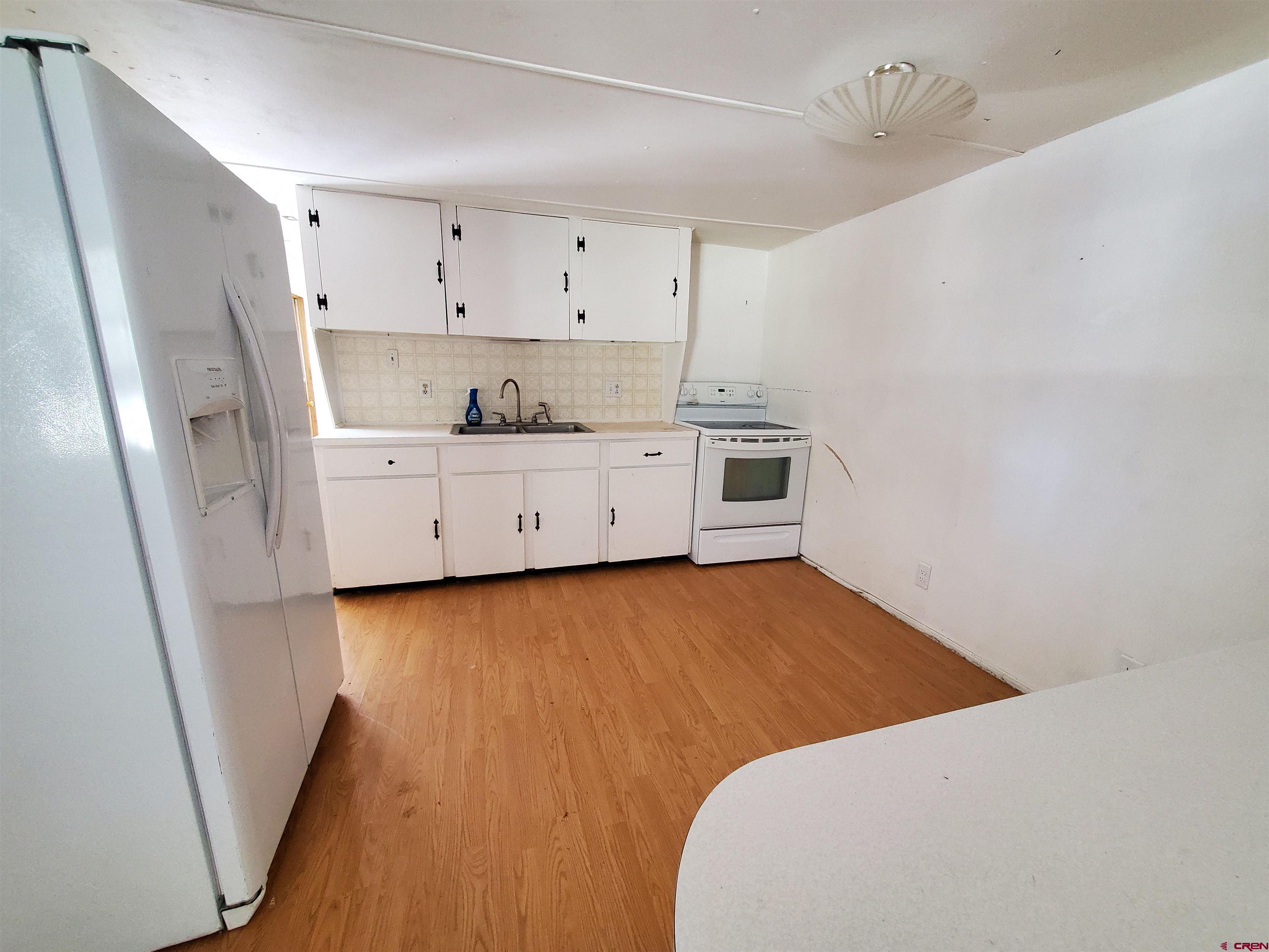 41559 Road H 25 Mancos Co 81328 Mancos, CO 81328 - Photo 5 of 20 a room with a bed and a dresser