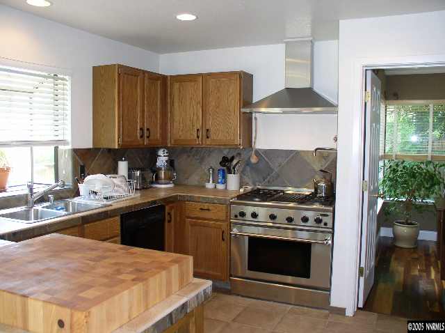140 Riverhaven Place Reno, NV 89519 - Photo 1 of 6 a kitchen with a stove a sink and a refrigerator