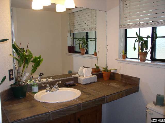 140 Riverhaven Place Reno, NV 89519 - Photo 6 of 6 a bathroom with a granite countertop sink and a mirror
