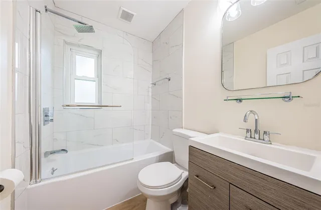 a bathroom with a sink a toilet and a bathtub