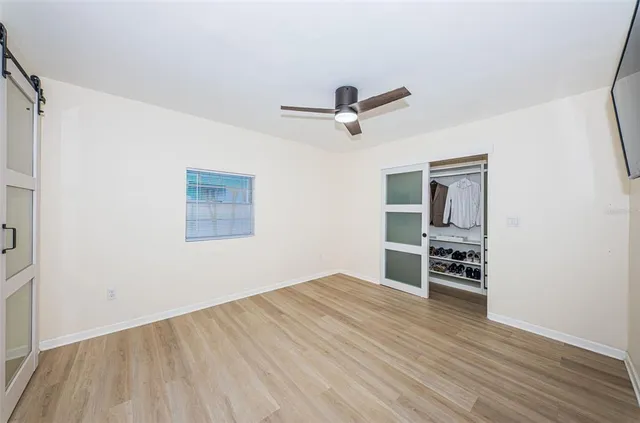 wooden floor in an empty room with a window