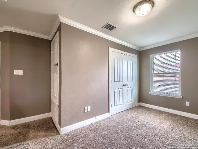 an empty room with windows and closet