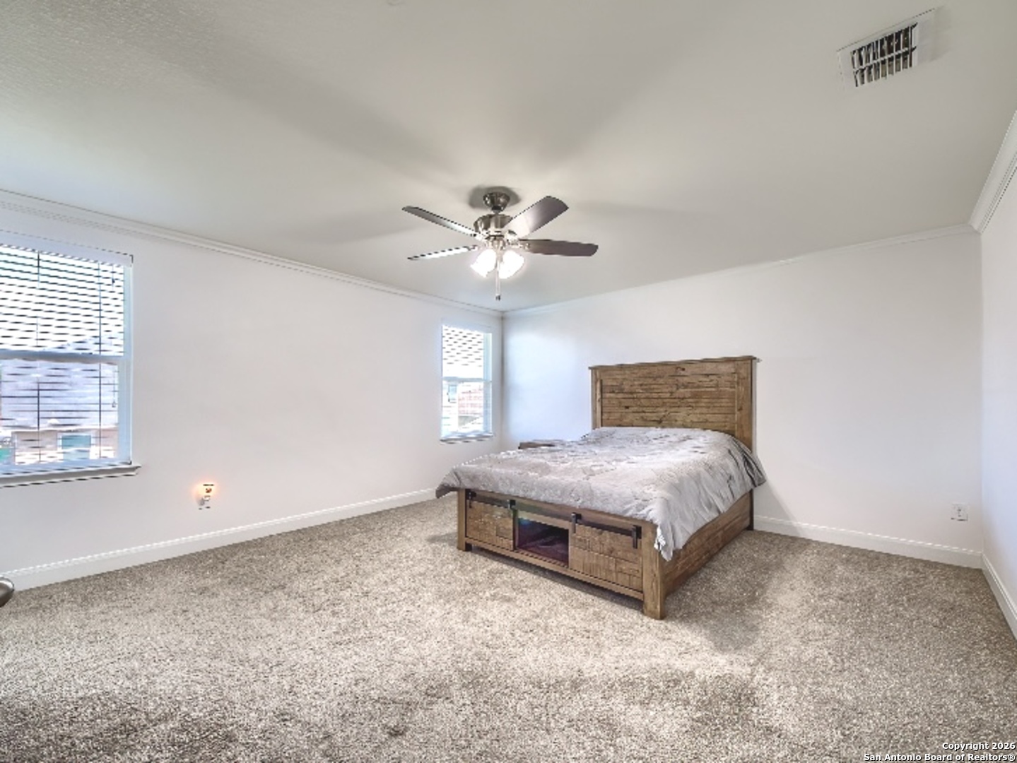 7566 Copper Cove Converse, TX 78109 - Photo 13 of 22 a spacious bedroom with a bed and window