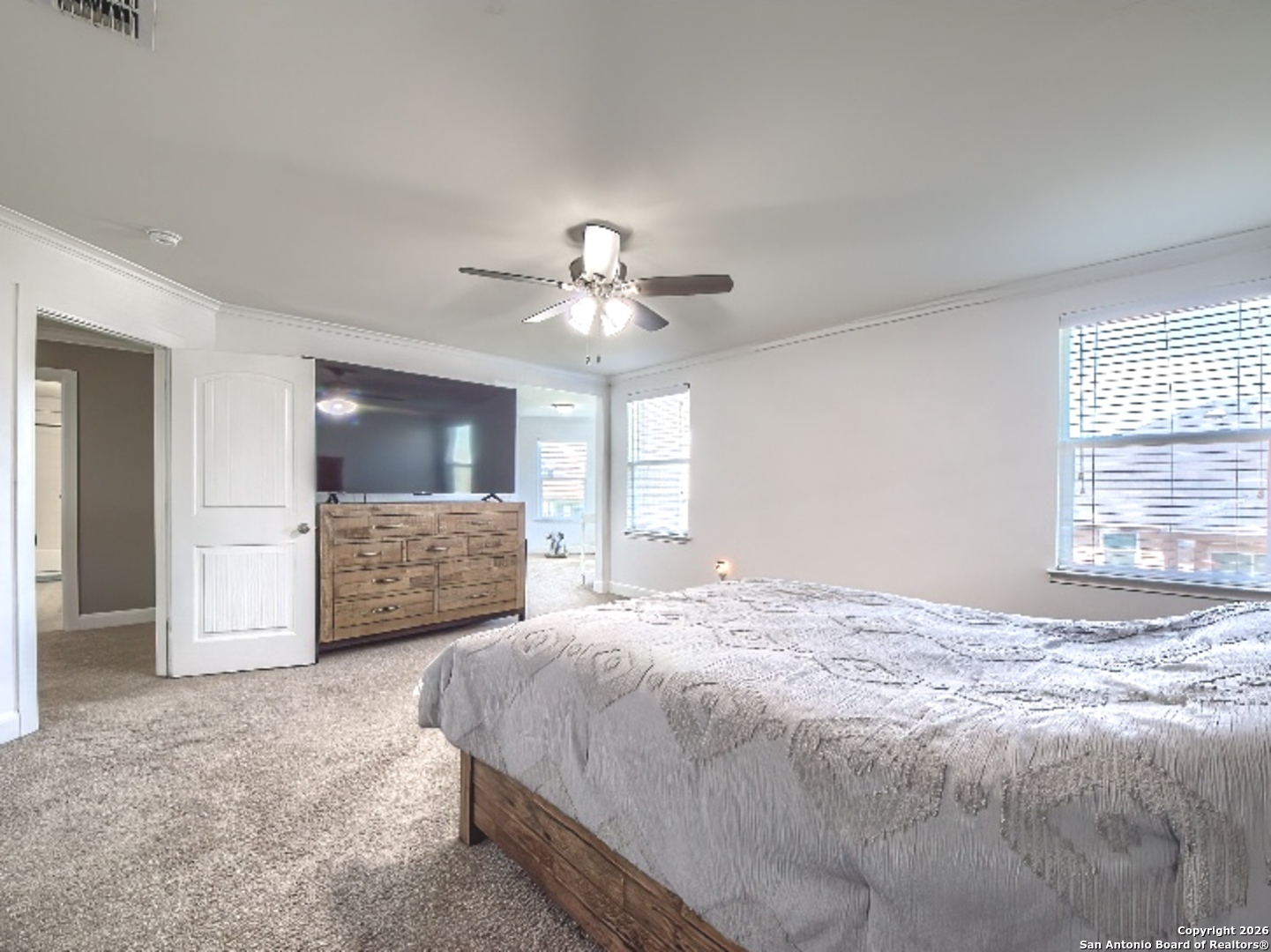 7566 Copper Cove Converse, TX 78109 - Photo 14 of 22 a spacious bedroom with a bed and a flat screen tv