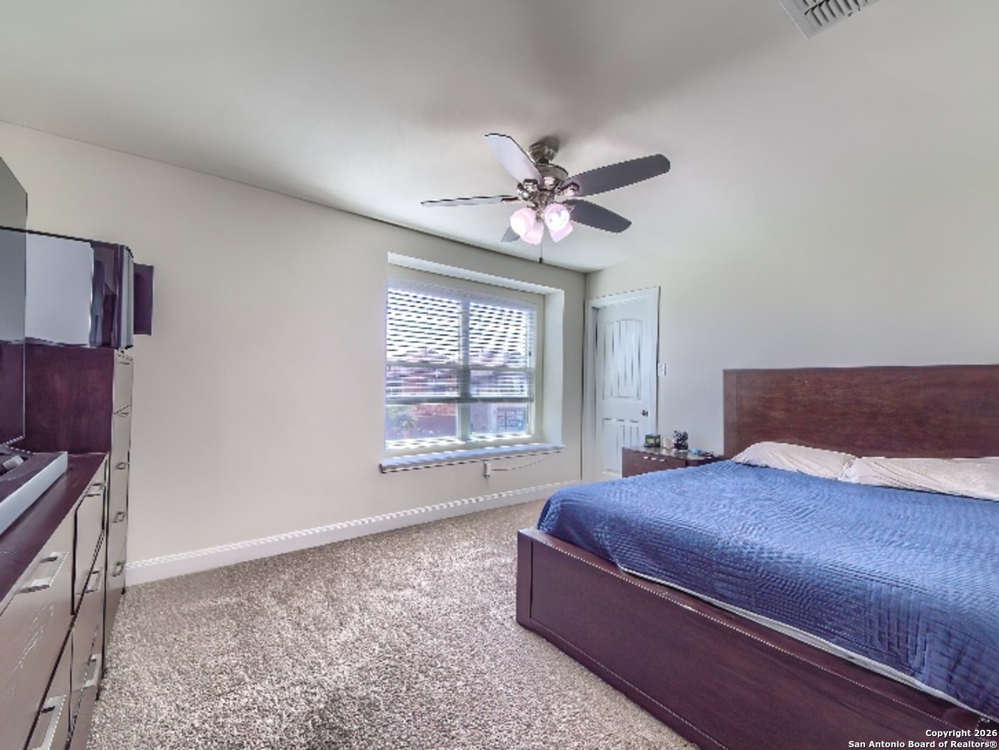 7566 Copper Cove Converse, TX 78109 - Photo 18 of 22 a bedroom with a large bed and a window
