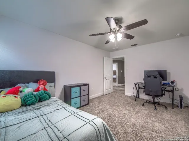 a bedroom with bed and a chandelier