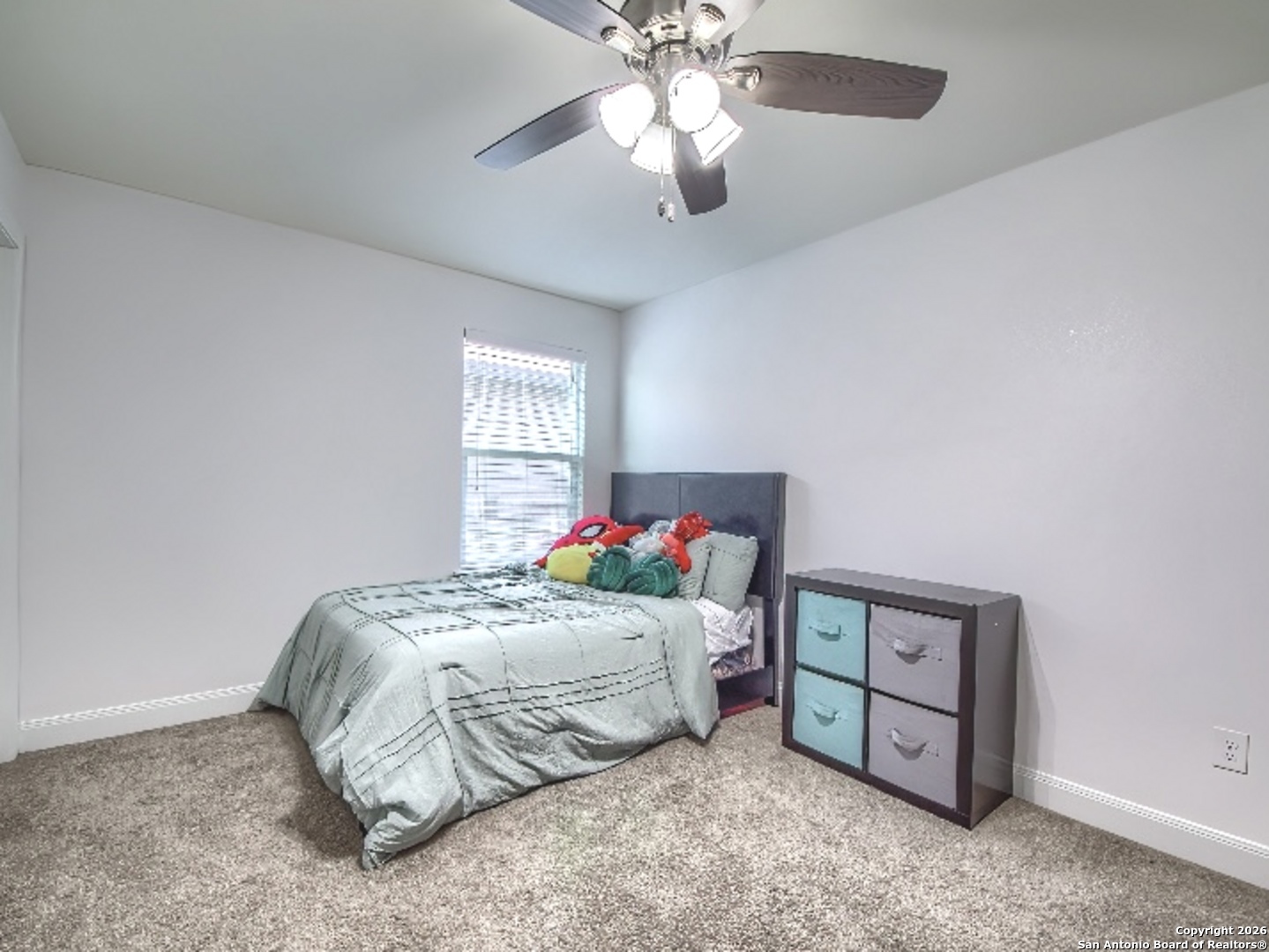 7566 Copper Cove Converse, TX 78109 - Photo 20 of 22 a bedroom with a bed and a chandelier fan