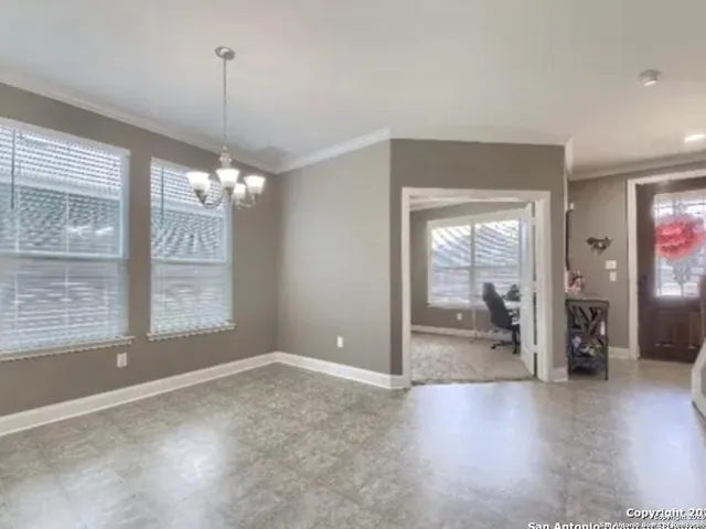 a view of a livingroom with a furniture wooden floor and a chandelier