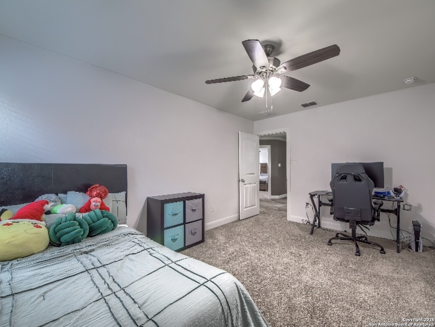 7566 Copper Cove Converse, TX 78109 - Photo 21 of 22 a bedroom with bed and a chandelier