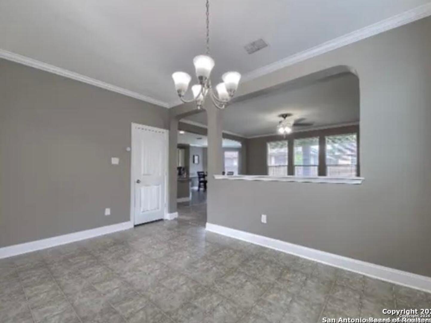 7566 Copper Cove Converse, TX 78109 - Photo 5 of 22 a view of a livingroom with a chandelier fan and windows